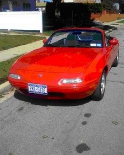 1995 white Miata on a city street